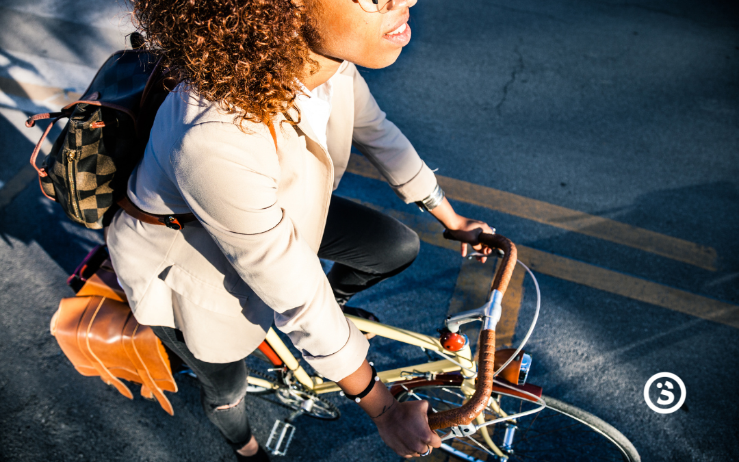 Woman riding her bike in the morning sun on the way to work